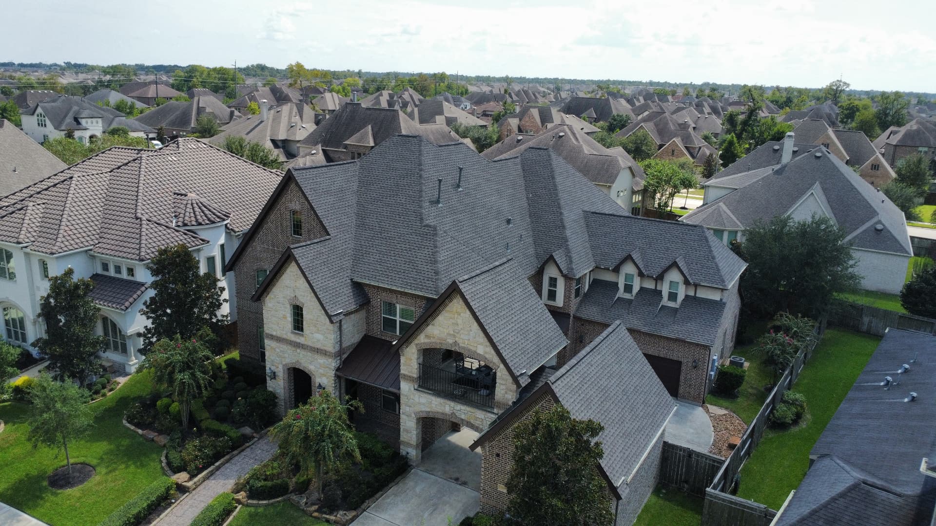 Aerial view of a large Houston-area home with a newly installed architectural shingle roof
