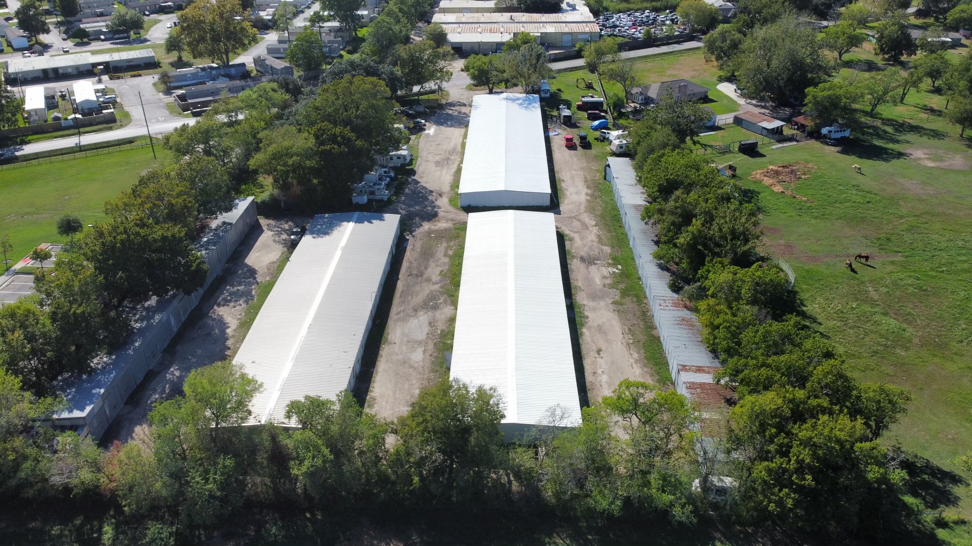Aerial view of a Houston-area commercial complex with long corrugated metal roofs — a BD Roofing & Contracting metal roofing project